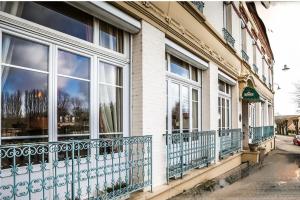 a building with windows and balconies on a street at Le Renaissance in Montdidier
