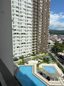 an aerial view of a large apartment building with a swimming pool at Avida Aspira Tower 1 - Chads Unit 8th Floor in Cagayan de Oro