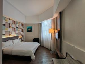 a hotel room with a bed and a window at Ajang Hotel in Miri +27 photos