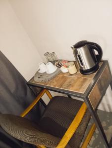 a table with a coffee pot and cups on it at Shakawe River Lodge in Shakawe