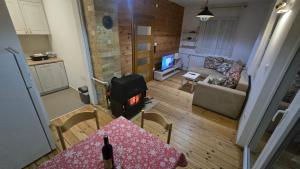 an aerial view of a living room with a stove at Bajka in Kolašin