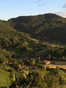 a view of a green valley with a mountain at Gîte La Source in Grusse