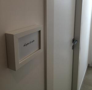 a bathroom door with a sign on the wall at B&B Acqua di Sale in Manfredonia