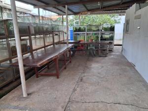 a group of picnic tables in a building at Fortune Room Stay 3 in Sandakan