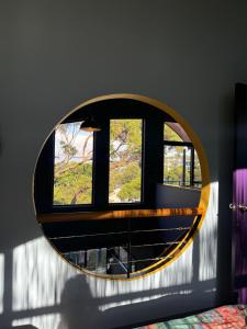 a circular mirror in a room with a window at Copacabana Fab & Funky in Copacabana