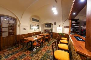 a restaurant with tables and chairs in a room at Restaurace a Penzion U Palečků in Skuteč