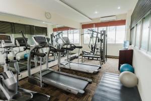 a gym with several tread machines in a room at Hotel Luwansa Palangkaraya in Palangkaraya