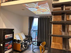 a living room with a couch and a balcony at Urban Nest - Đông Ngạc in Hanoi
