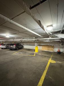 a parking garage with cars parked in it at Bedford Plaza Hotel - Boston in Bedford