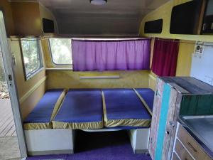 an empty bed in the back of an rv at Forest Gypsy Tiny Home in Barkers Vale