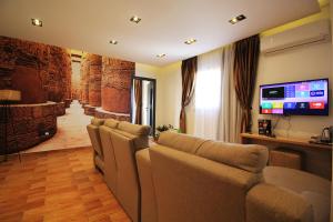 a living room with a bunch of chairs and a flat screen tv at Palm Pyramids View INN in Cairo +87 photos