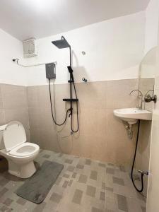 a bathroom with a shower and a toilet and a sink at GetAway Apartment in El Nido +13 photos