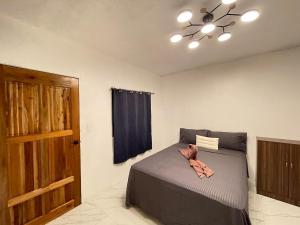 a bedroom with a bed and a ceiling fan at GetAway Apartment in El Nido