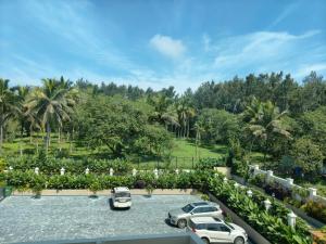 a group of cars parked in a parking lot at Captains Crown Hotels & Resorts in Kushālnagar