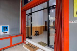 an entrance to a building with a p sign on the door at Urbanview Hotel near Exit Tol BSD in Ciater-hilir +17 photos