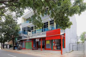 an apartment building with a colorful facade on a street at Urbanview Hotel near Exit Tol BSD in Ciater-hilir