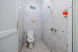a bathroom with a shower and a toilet at Urbanview Hotel near Exit Tol BSD in Ciater-hilir