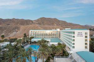 a view of the mgm hotel with palm trees and mountains at Yam Suf by Isrotel Collection in Eilat