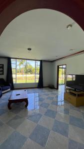 a living room with a table and a tv at Liina House in Ko Yao Noi