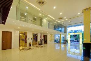 a large building with a large lobby with glass doors at Dolphin Bay Hotel Nha Trang in Nha Trang