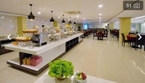 a restaurant with a buffet line with food on it at Dolphin Bay Hotel Nha Trang in Nha Trang