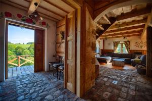 a living room with a couch and a room with a window at Maciejewka in Zahoczewie