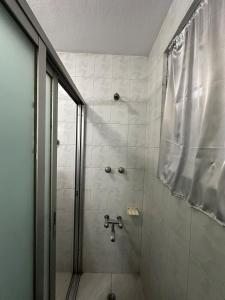 a bathroom with a shower with a shower curtain at Manang De cafe B and B in Kathmandu