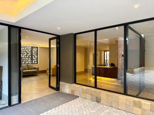 a living room with glass windows and a couch at Kozi - Wilson Airport in Nairobi +19 photos