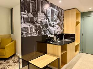 a kitchen with a sink and a painting on the wall at Kozi - Wilson Airport in Nairobi