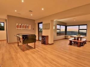 a large room with a pool table in a house at Roxana Guestrooms in Johannesburg