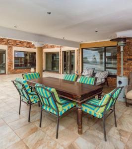 a wooden table and chairs in a living room at Roxana Guestrooms in Johannesburg