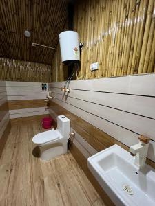 a bathroom with a toilet and a sink at Radhika resort in Vrindāvan