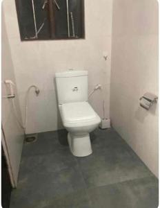 a bathroom with a white toilet in a stall at Dragon beach in Dondra West +26 photos