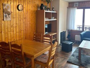 a dining room with a wooden table and chairs at Apartment in Veysonnaz with pool in Veysonnaz