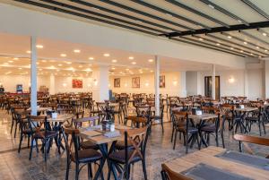a dining room with tables and chairs in it at Eflina Resort - Halal All Inclusive in Alanya