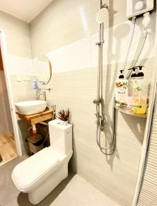 a bathroom with a toilet and a shower and a sink at Ahava Boutique Hotel in Pooc
