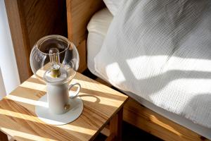 a nightstand with a coffee maker on a table next to a bed at 天然温泉-富士山パノラマビュー-プライベートデッキで非日常体験を-伊豆の温泉付き貸別荘-中伊豆noie in Izu