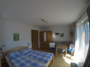 a bedroom with a bed and a table and chairs at Privatzimmer Helene Mariacher in Virgen