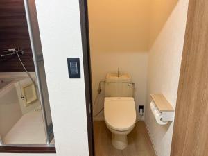 a bathroom with a toilet in a small room at フレグランスショーワ in Matsue