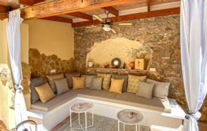 a couch in a room with a stone wall at Casa Vida Arta in Artá