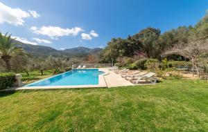a swimming pool with lounge chairs in a yard at Sa Tafona in Esporles