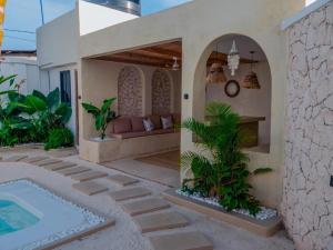 a house with a patio and a swimming pool at Villa Moja in Nungwi