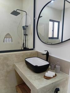 a bathroom with a sink and a large mirror at Villa Moja in Nungwi +15 photos