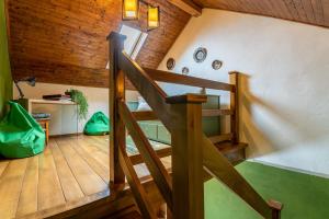 a staircase in a room with a wooden ceiling at Grandma’s Cottage in Săcele