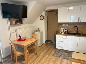 a kitchen and dining room with a table and a sink at Apartment Gajsek in Zavrč