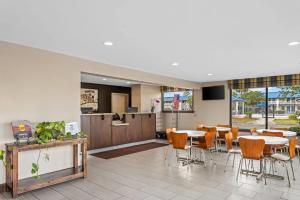 a dining room with tables and chairs in a building at Super 8 by Wyndham Valdosta GA I-75 in Valdosta