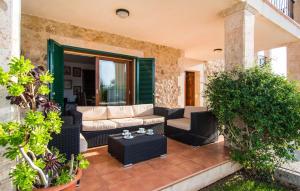 a patio with a couch and chairs and plants at Ca Na Siona in Alcudia