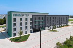 a large building with the words electrocutes at ECHO Suites Extended Stay by Wyndham Dallas Plano Richardson in Plano