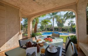 a dining room with a table and a view of a pool at Can Gual in Inca
