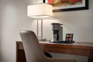 a desk with a chair and a coffee maker at La Quinta Inn by Wyndham Vancouver Airport in Richmond +37 photos